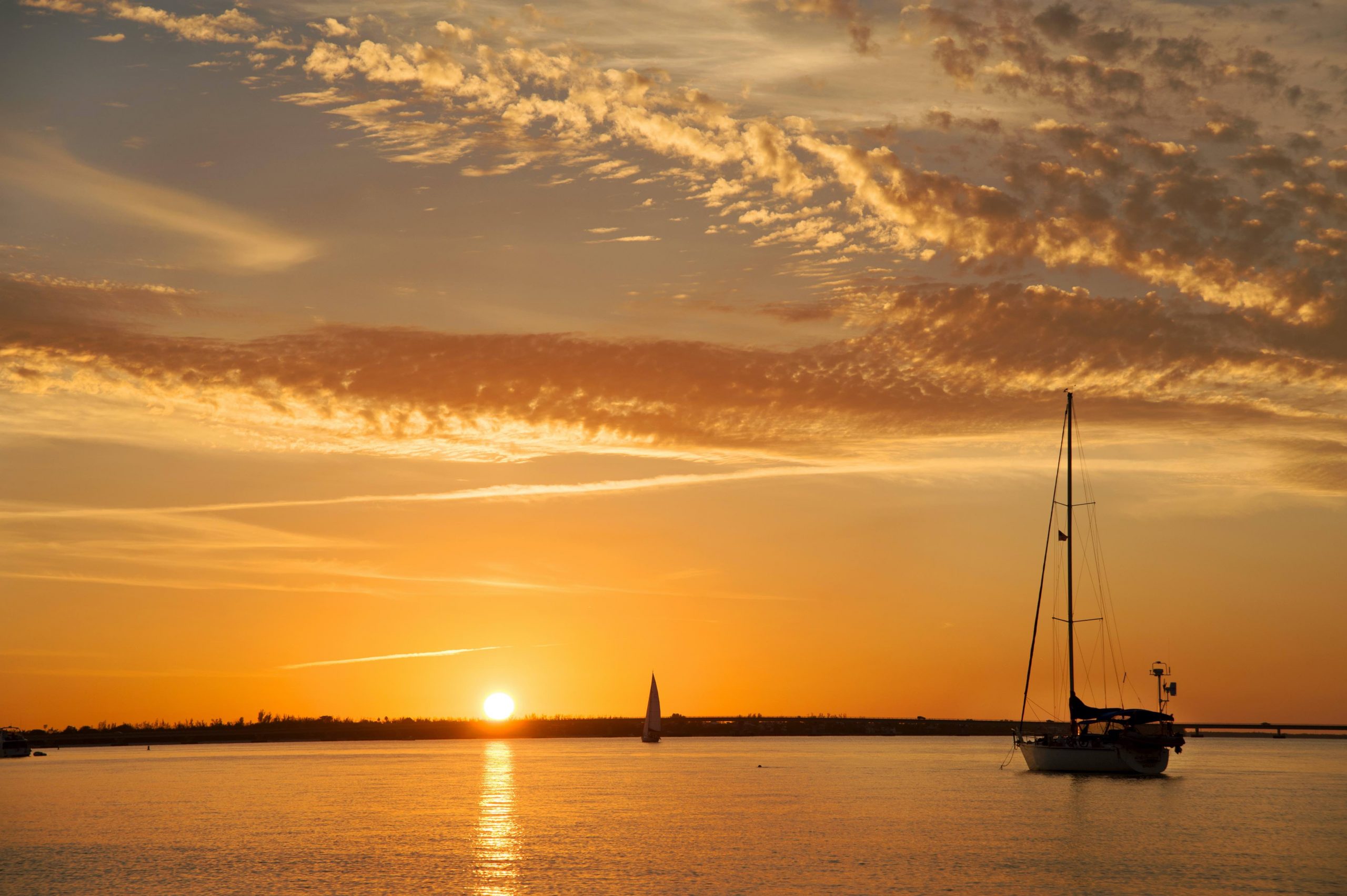 A yellow sun rises above the ocean in the Sanibel area. 