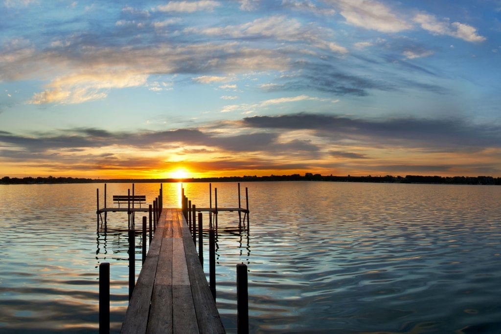 sunrose over a dock on a lake offers a feeling of healing and restoration