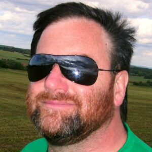 Al Drinkwalter, melanoma survivor, wears sunglasses that reflect the sun. 