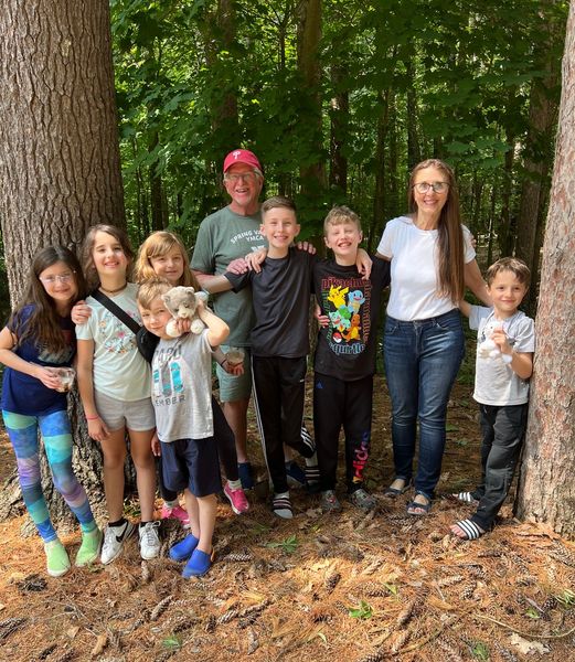 Lynn Eib, author and cancer survivor, smiles for a picture with her husband and grandkids.